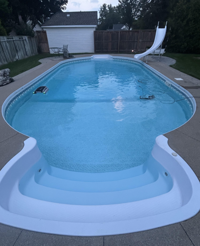 Completed custom pool beside a modern white home